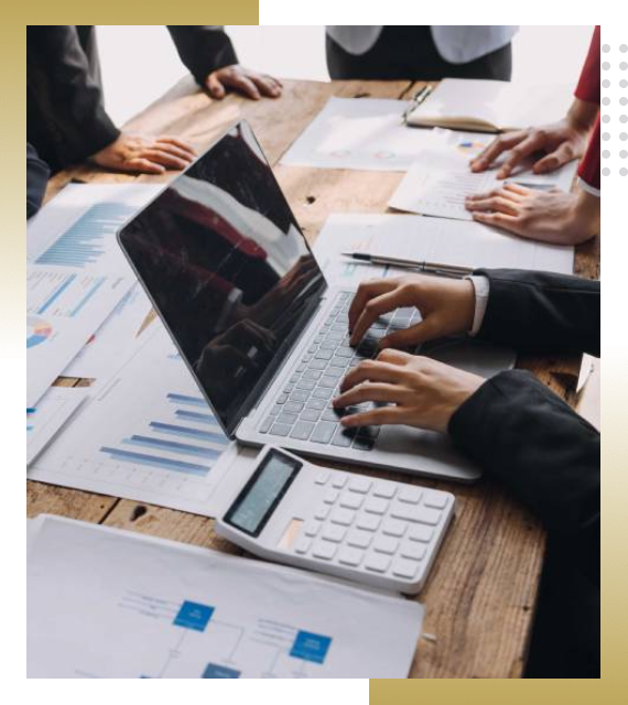 Business team analyzing financial charts with calculator and laptop.