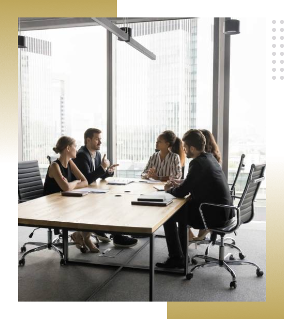 Business meeting with five professionals discussing work at a conference table.